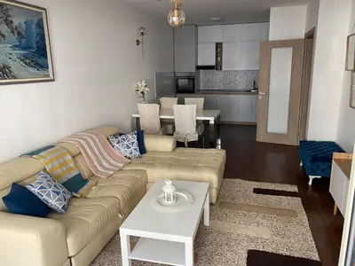 a living room with a couch and a table at Apartman City Kvart Podgorica lux in Podgorica