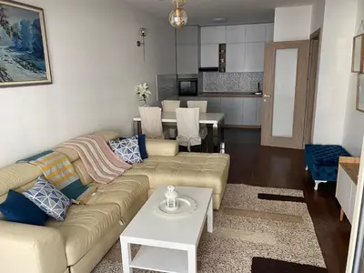 a living room with a couch and a table at Apartman City Kvart Podgorica lux in Podgorica