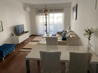a living room with a table and a couch at Apartman City Kvart Podgorica lux in Podgorica