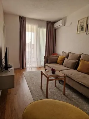 a living room with a couch and a coffee table at Rosemary in Podgorica