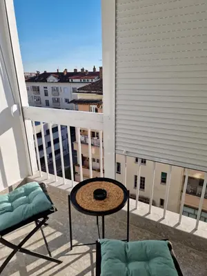 a balcony with a table and chairs and a view at Rosemary in Podgorica