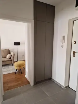 a room with a closet and a chair and a table at Rosemary in Podgorica