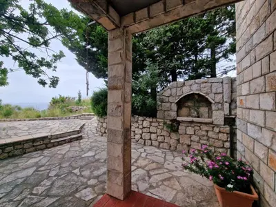 an outdoor patio with a stone pizza oven at Cliff House in Budva