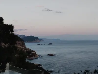 a view of the ocean with rocks in the water at Cliff House in Budva
