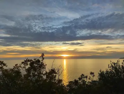 a sunset over a large body of water at Cliff House in Budva