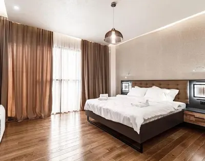 a bedroom with a large bed and a large window at Penthouse Victoria in Budva