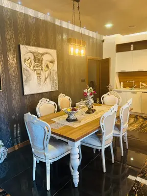 a dining room with a wooden table and chairs at Penthouse Victoria in Budva