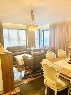 a living room with a couch and a table at Penthouse Victoria in Budva