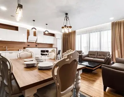 a kitchen and dining room with a table and chairs at Penthouse Victoria in Budva