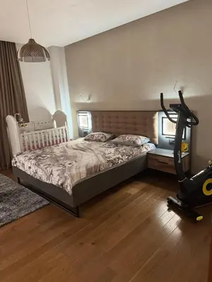 a bedroom with a bed and a exercise bike at Penthouse Victoria in Budva