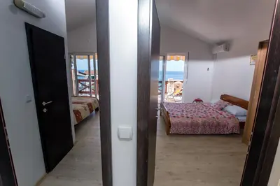 a room with a bedroom with a bed and a door at Holiday Home Siesta in Dobra Voda