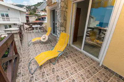 two yellow chairs and a table on a patio at Holiday Home Siesta in Dobra Voda