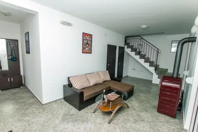 a living room with a couch and a staircase at Holiday Home Siesta in Dobra Voda