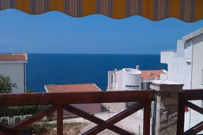 a view of the ocean from a balcony at Holiday Home Siesta in Dobra Voda