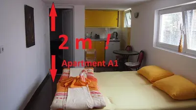 a bedroom with a bed with two arrows pointing into a room at Marko Apartment in Sutomore