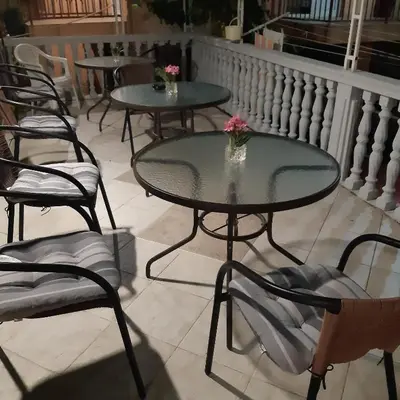 a group of tables and chairs on a balcony at Marko Apartment in Sutomore