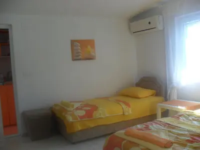 a room with two beds in a room at Marko Apartment in Sutomore