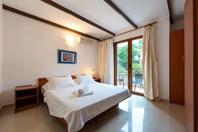 a bedroom with a bed with a towel on it at Maslina Residence in Budva