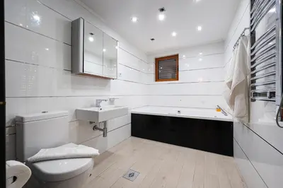 a white bathroom with a sink and a toilet at Maslina Residence in Budva