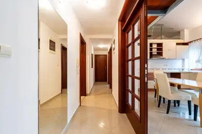a kitchen and dining room with a table and chairs at Maslina Residence in Budva