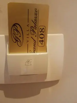 a cup of coffee sitting on top of a holder at Apartments and Rooms Grand Palazzo in Budva