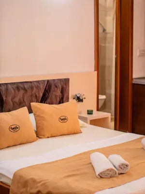 a bedroom with a bed with two pillows at Apartments Bonita in Ulcinj