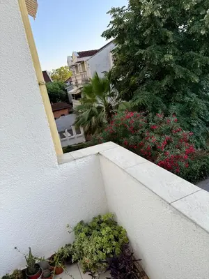 a balcony with flowers and plants on a house at Center Oasis Retreat in Podgorica