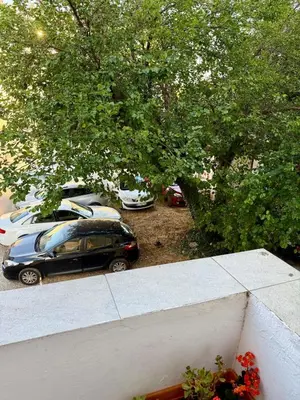 a car parked in a parking lot with parked cars at Center Oasis Retreat in Podgorica
