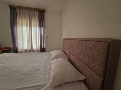 a bedroom with a large bed with two pillows at City Haven Deluxe in Podgorica