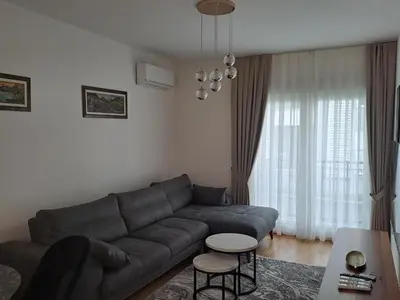 a living room with a couch and a table at Apartman Podgorica Vlado 1 in Podgorica