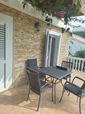 a black table and chairs on a patio at Apartments at Villa with swimming pool&parking in Budva