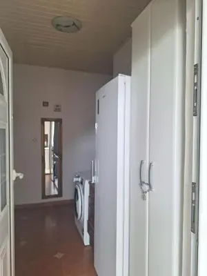 a kitchen with a white refrigerator in a room at Apartments at Villa with swimming pool&parking in Budva