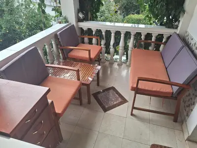 two benches and a table on a balcony at Apartments at Villa with swimming pool&parking in Budva