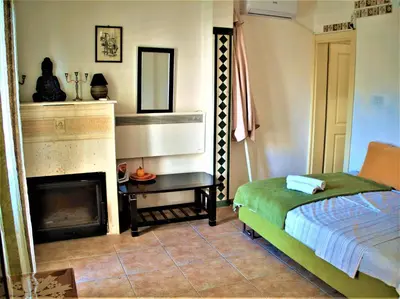 a bedroom with a bed and a fireplace at Apartments at Villa with swimming pool&parking in Budva