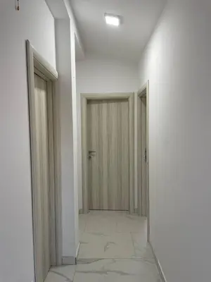 an empty hallway with two doors and a tile floor at Private house in the Capital City of Montenegro in Podgorica