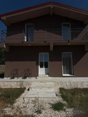 a house with two chairs and a balcony at Private house in the Capital City of Montenegro in Podgorica