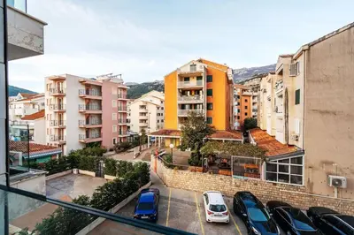 a city with cars parked in a parking lot at Status-M Apartments Nexsan1 in Budva