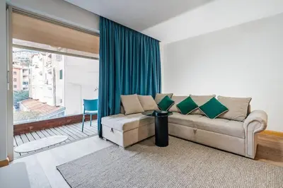 a living room with a couch and a large window at Status-M Apartments Nexsan1 in Budva