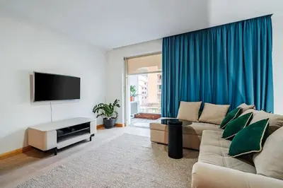 a living room with a couch and a flat screen tv at Status-M Apartments Nexsan1 in Budva