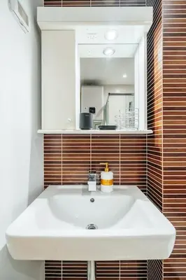 a bathroom with a white sink and a mirror at Status-M Apartments Nexsan1 in Budva