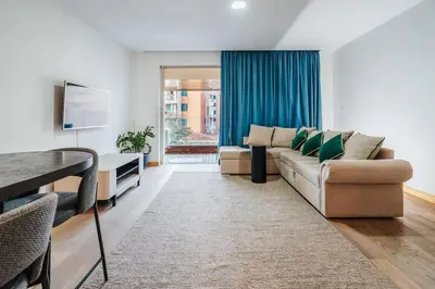 a living room with a couch and a table at Status-M Apartments Nexsan1 in Budva