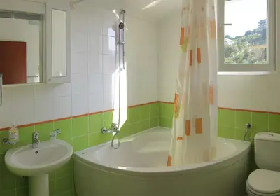 a bathroom with a tub and a sink and a toilet at Villa Rossa in Utjeha