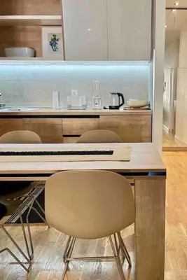 a kitchen with a table with chairs and a counter at Studio 38 - Modern Studio in Budva in Budva