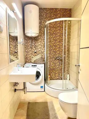 a bathroom with a sink and a washing machine at Studio 38 - Modern Studio in Budva in Budva