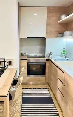 a kitchen with a sink and a tub and a table at Studio 38 - Modern Studio in Budva in Budva