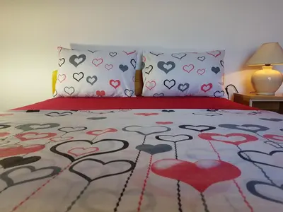 a bedroom with a bed with hearts on it at Apartments Taida in Dobra Voda