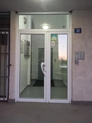 an entrance to a building with glass doors at Apartment near hospital Podgorica in Podgorica