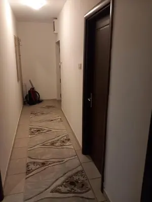 a hallway with a door and a tile floor at Apartment near hospital Podgorica in Podgorica