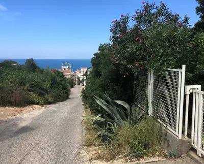 a fence on the side of a road near the ocean at Apartment Cats in Utjeha