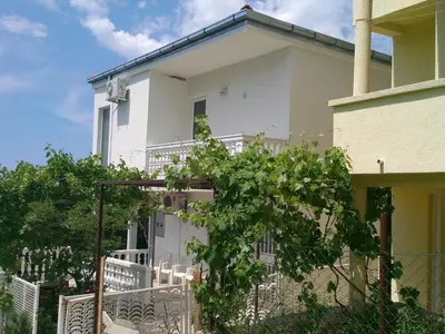 a white house with a gate and a fence at Apartment Cats in Utjeha